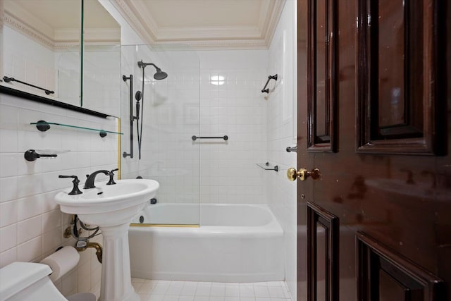 full bathroom with shower / tub combination, tile patterned flooring, toilet, tile walls, and crown molding