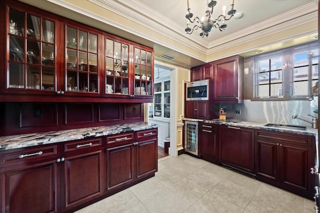 kitchen with reddish brown cabinets, beverage cooler, light stone counters, and glass insert cabinets