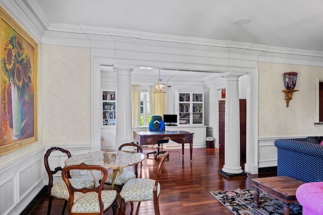 interior space with decorative columns, dark wood finished floors, wainscoting, ornamental molding, and a decorative wall