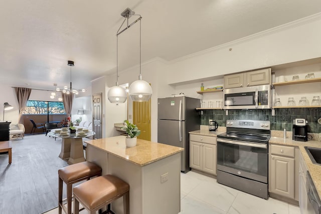 kitchen with a breakfast bar area, open shelves, stainless steel appliances, hanging light fixtures, and a kitchen island