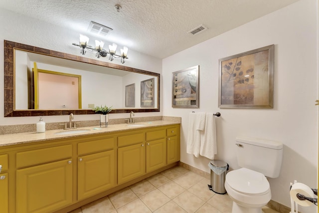 full bathroom featuring a textured ceiling, a sink, visible vents, and tile patterned floors