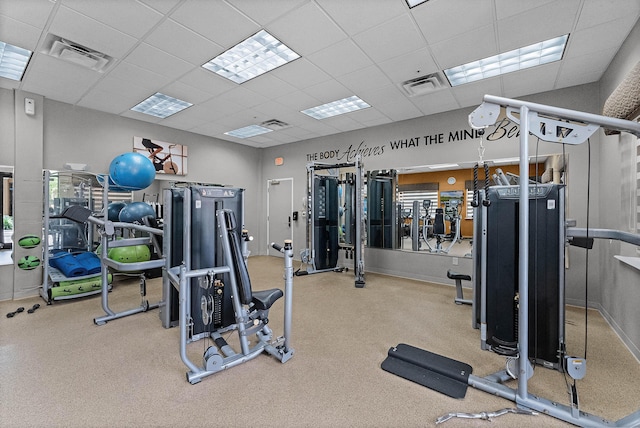 exercise room featuring a paneled ceiling and visible vents