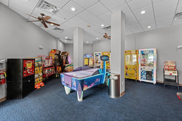 recreation room featuring a ceiling fan, visible vents, and dark carpet