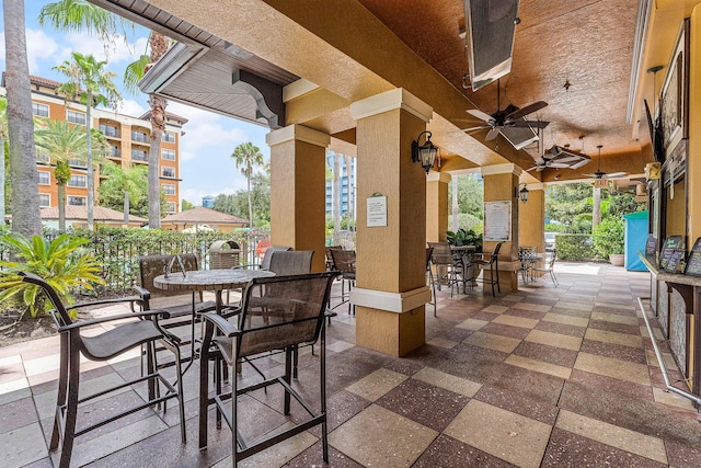 view of patio with outdoor dining space and a ceiling fan