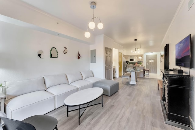 living room featuring light wood-type flooring, electric panel, and crown molding