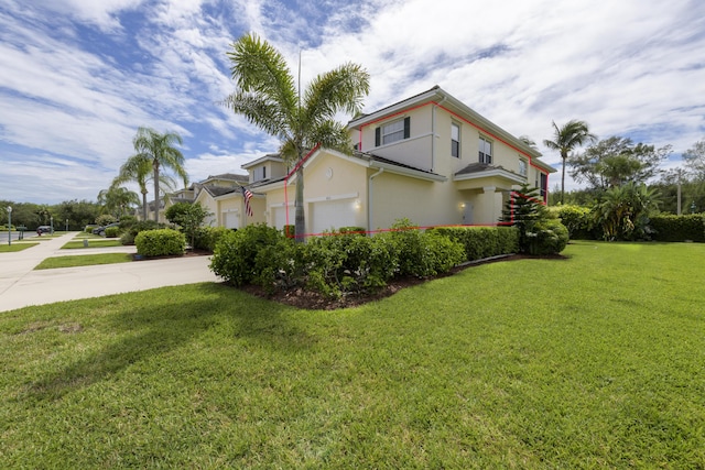 view of property exterior with concrete driveway, a lawn, an attached garage, and stucco siding