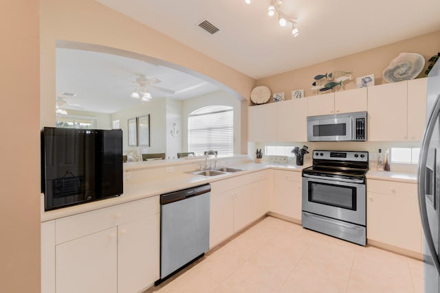 kitchen featuring light tile patterned flooring, sink, a healthy amount of sunlight, ceiling fan, and stainless steel appliances