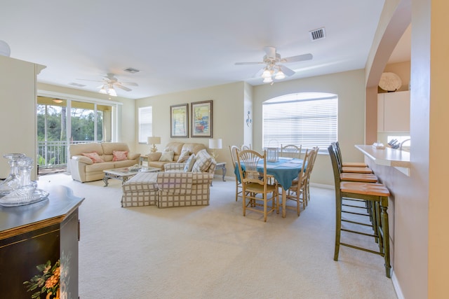 living room featuring ceiling fan and light carpet