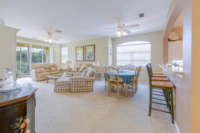 living room featuring ceiling fan and light colored carpet