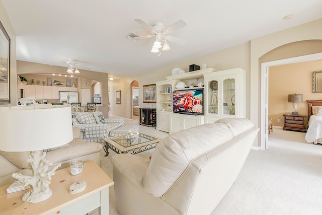 carpeted living room featuring ceiling fan