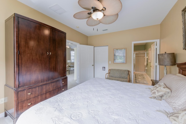 carpeted bedroom with a closet, ceiling fan, and connected bathroom