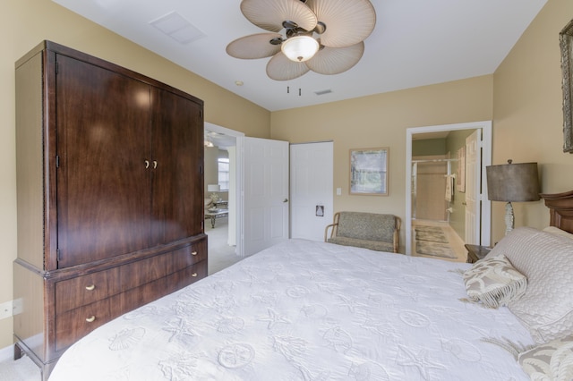 bedroom with light carpet, ensuite bath, ceiling fan, and visible vents