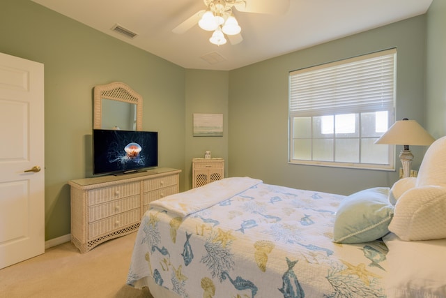 bedroom with light carpet, baseboards, visible vents, and a ceiling fan