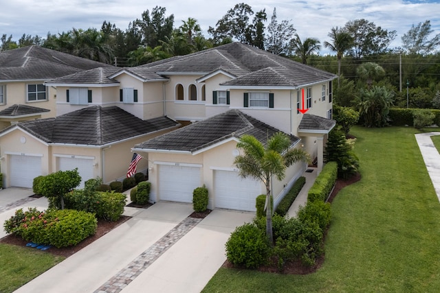 view of front of home with a front yard and a garage