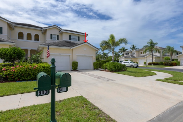 view of front of property featuring a garage and a front yard