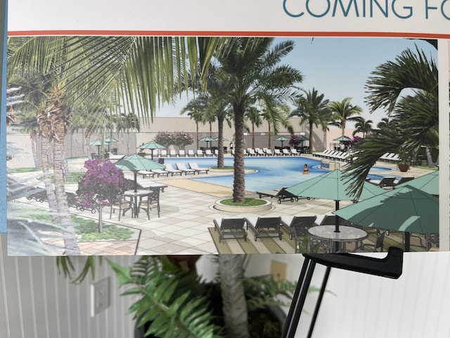 pool with a patio area and fence