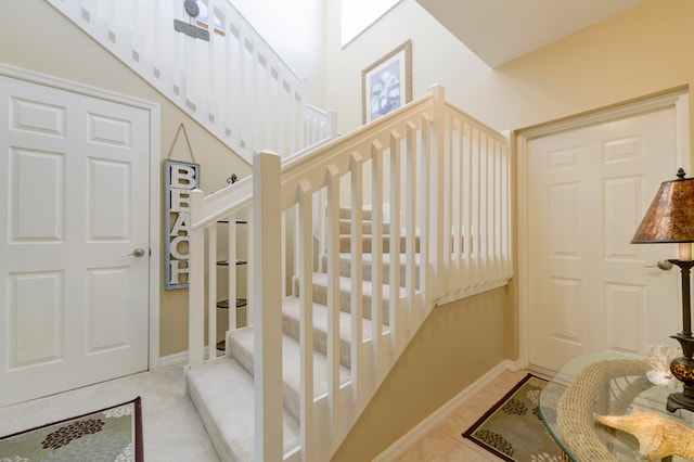 staircase featuring tile patterned flooring