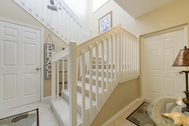 stairway with tile patterned flooring and baseboards