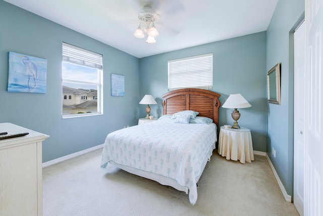 carpeted bedroom featuring a closet and ceiling fan