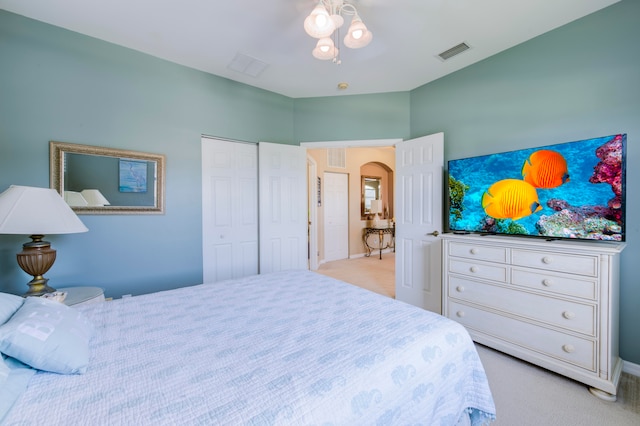 bedroom with a closet and light carpet