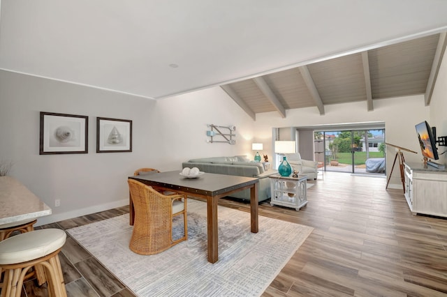 interior space with vaulted ceiling with beams and hardwood / wood-style flooring