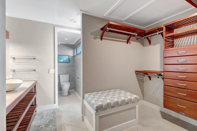 walk in closet featuring light tile flooring