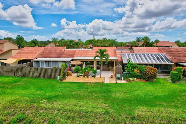 rear view of property featuring a yard