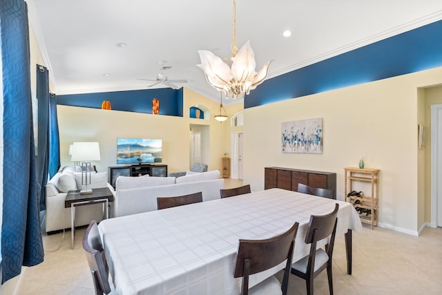 dining area with lofted ceiling, light tile patterned floors, ceiling fan with notable chandelier, and ornamental molding