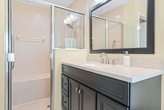 bathroom featuring vanity and a shower with shower door