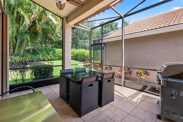 view of patio / terrace with ceiling fan, grilling area, and a lanai