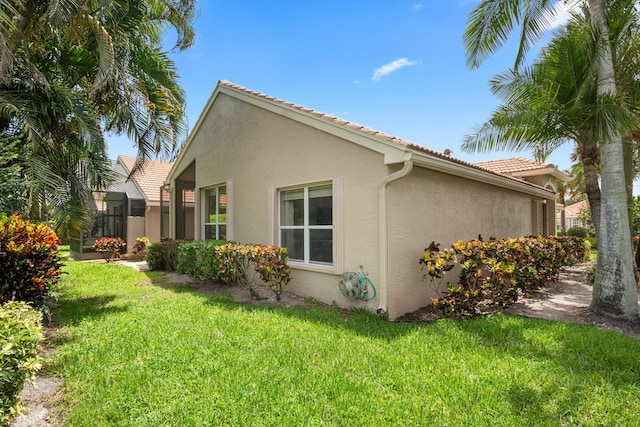 view of side of property with a yard