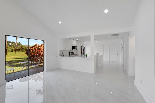 kitchen featuring appliances with stainless steel finishes, white cabinets, and light tile flooring