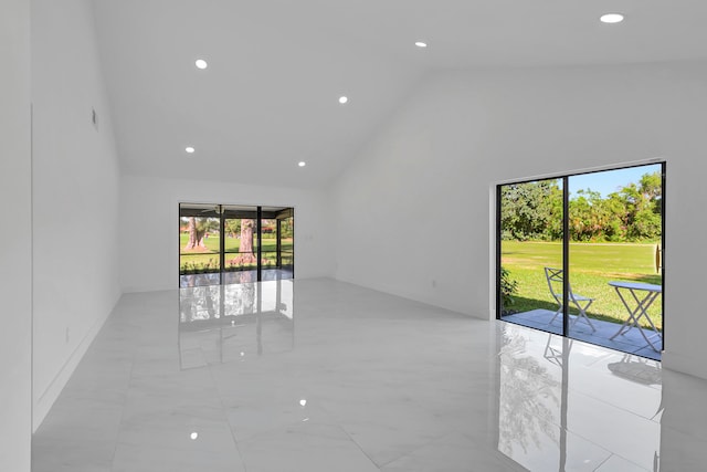 tiled empty room with high vaulted ceiling and plenty of natural light