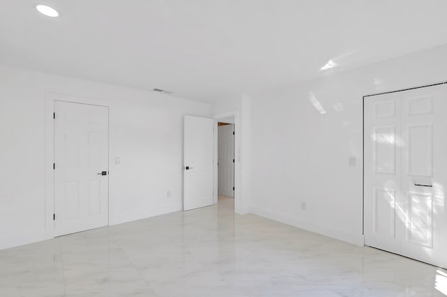 unfurnished room featuring light tile flooring