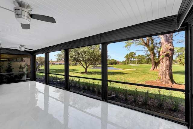 unfurnished sunroom with ceiling fan