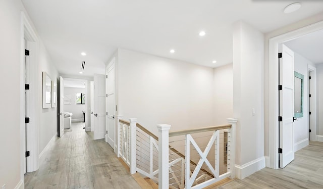 hall with light hardwood / wood-style floors