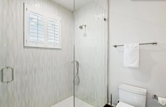 bathroom with toilet and walk in shower