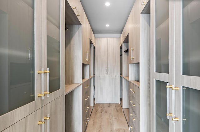 walk in closet featuring light hardwood / wood-style flooring