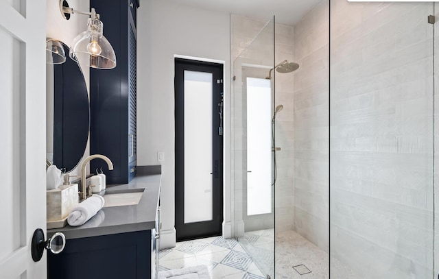 bathroom with vanity and a tile shower