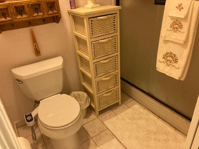 bathroom featuring toilet and tile patterned floors