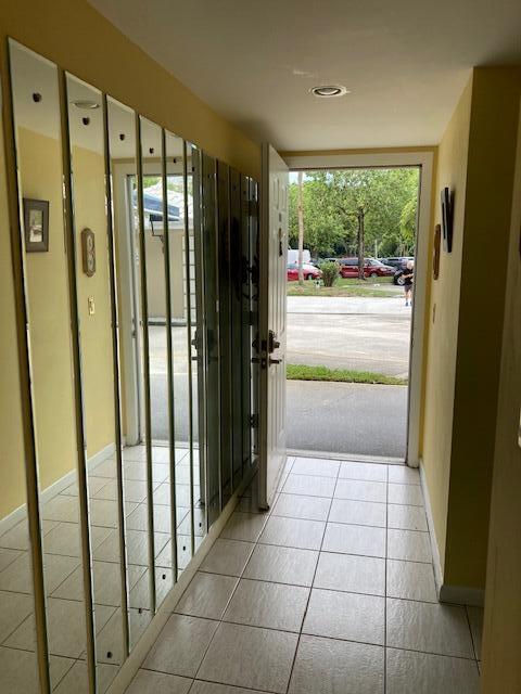 doorway to outside with light tile patterned floors