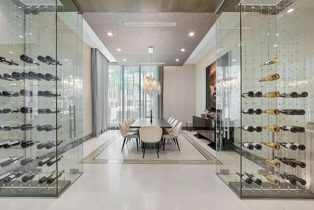 wine area with tile patterned flooring, floor to ceiling windows, and recessed lighting