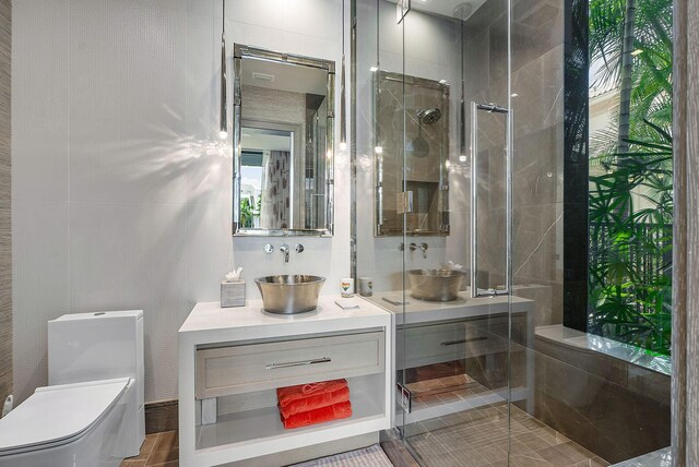 bathroom with vanity, toilet, and a shower with shower door