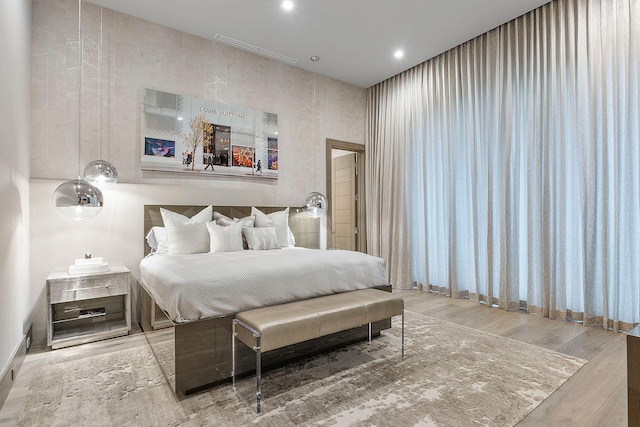 bedroom featuring light wood finished floors and recessed lighting