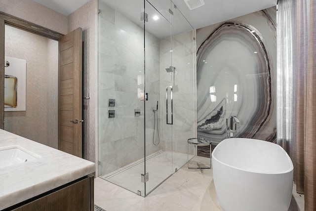 bathroom with marble finish floor, visible vents, a stall shower, vanity, and a freestanding tub