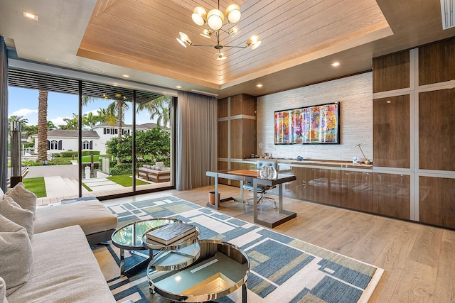 living area with wooden ceiling, expansive windows, a tray ceiling, light wood-style floors, and a notable chandelier