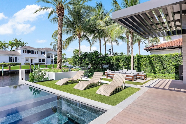 view of swimming pool with an outdoor living space and a jacuzzi