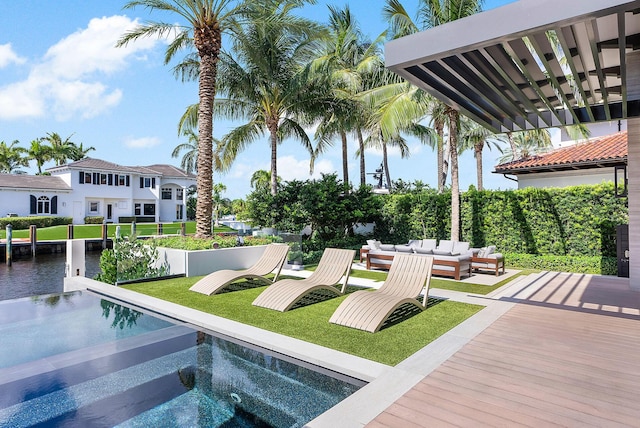 exterior space featuring fence, an outdoor hangout area, a fenced in pool, and a yard