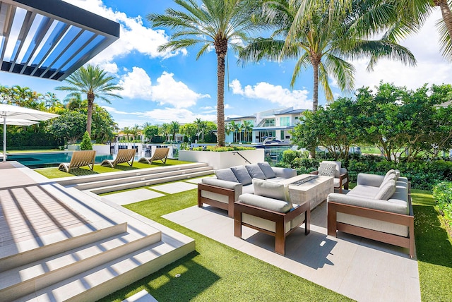 view of patio / terrace with an outdoor living space with a fire pit and an outdoor pool