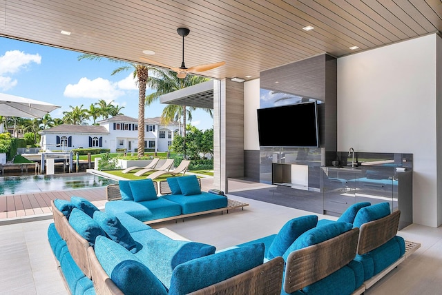 view of patio / terrace with a ceiling fan, a residential view, outdoor lounge area, and an outdoor kitchen